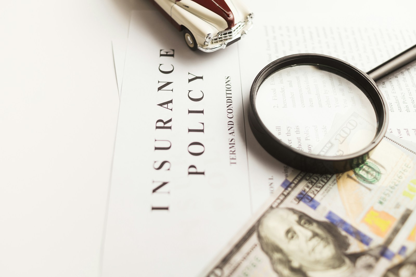 a magnifying glass sitting on top of a piece of paper, auto claim